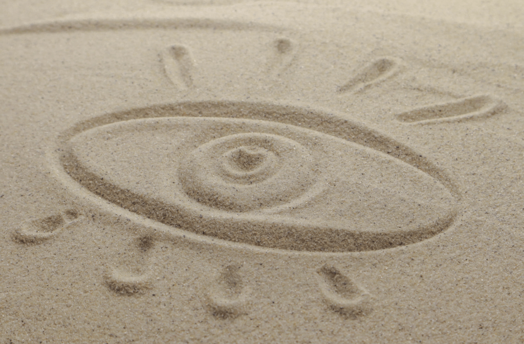 A drawing of an eye in sand to describe the feeling of having dry eyes